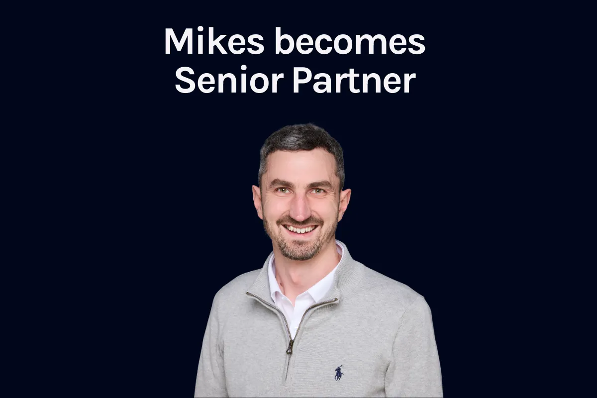 Mike Scott photographed against a navy background, announcing his appointment as Senior Partner.