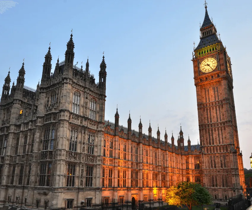 The Houses of Parliament and Big Ben lit up at dusk.